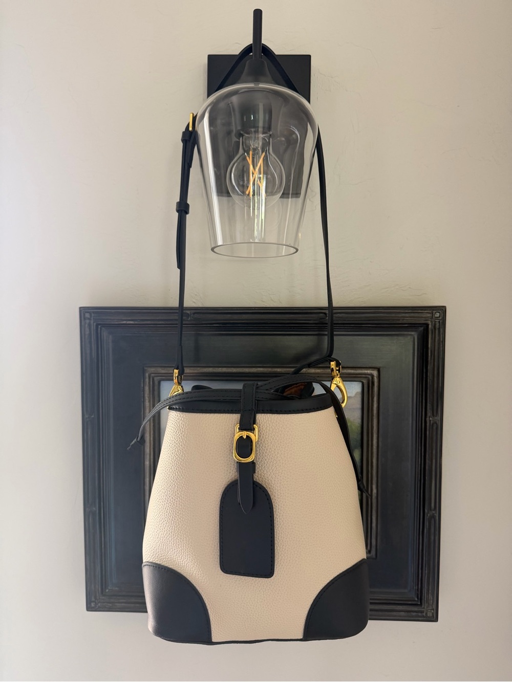 Cream and Black Pebbled Leather Crossbody Bucket Bag with Gold Accents